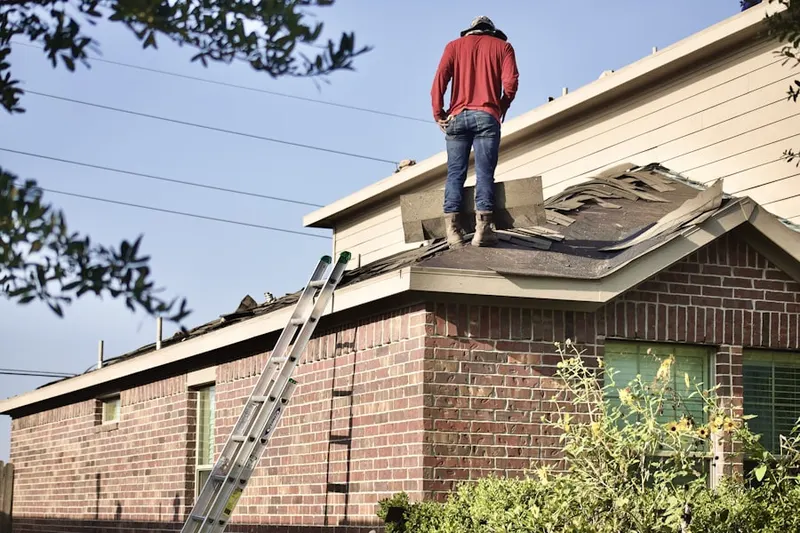 Professional roofer working on a residential roof in Bammel Forest
